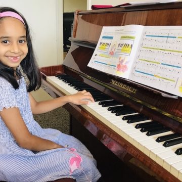 A big smile from Thenuki G. who has just finished her Piano Method Book 2.