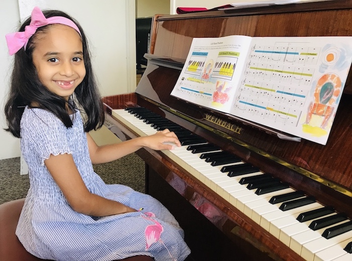 A big smile from Thenuki G. who has just finished her Piano Method Book 2.